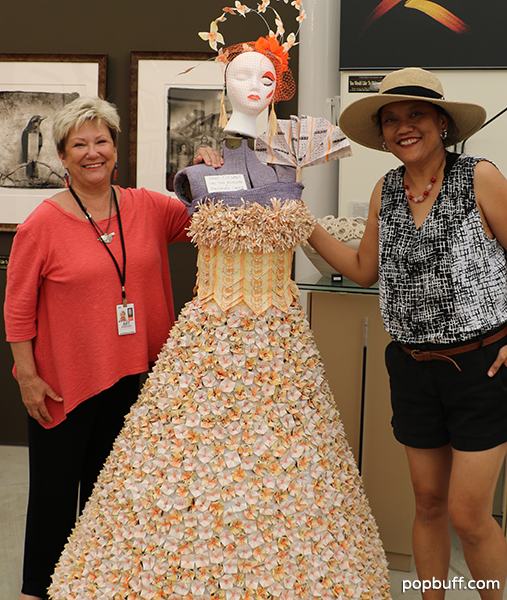 Artist Nancy Klann-Moren (left) won the award most elegant on the runway. Her piece is made of old lottery tickets with orange pins.