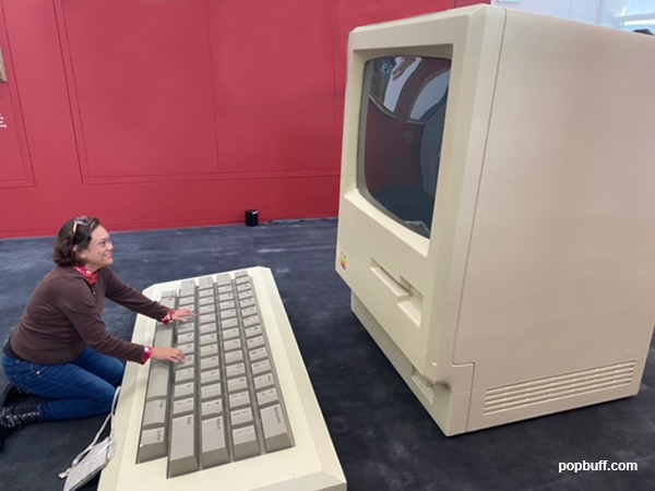 Blogger Ruchel Freibrun having a photo-op with an 80s/90s apple computer at Mr. Brainwash Art Museum in Beverly Hills
