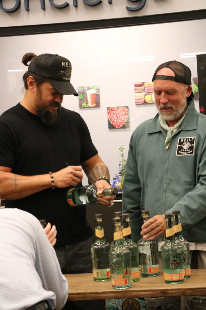 Jason Momoa and Blaine Halvorson stopped by at Pavilions in Laguna Beach to promote Meili Vodka and to meet fans - Popbuff.com
