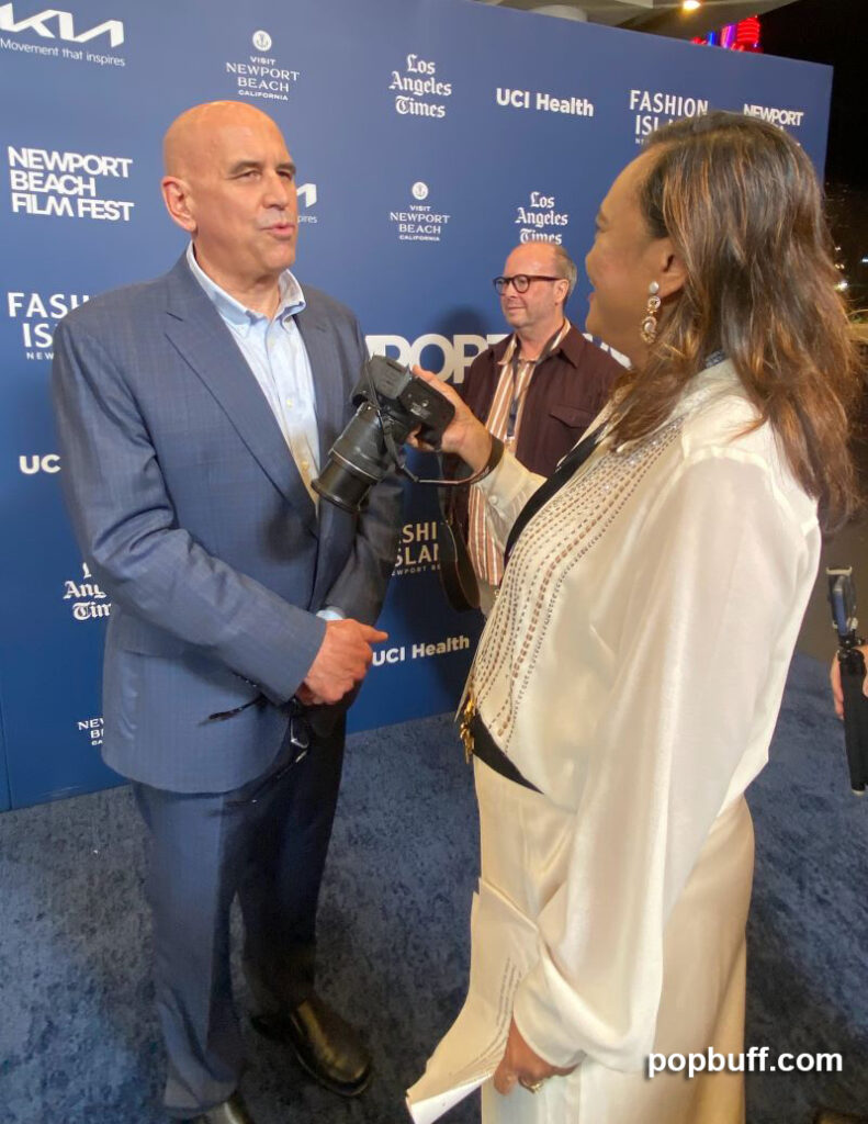 Popbuff blogger Ruchel Freibrun interviews Newport Beach Film Festival CEO Greg Schwenk on the blue carpet. - Popbuff.com